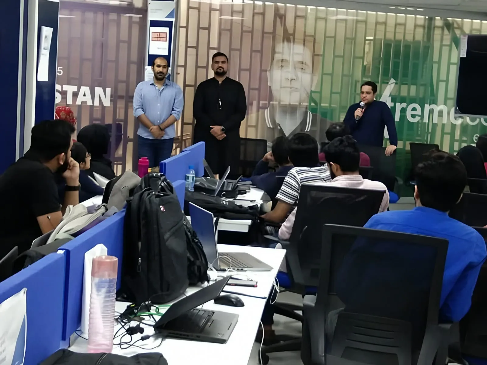 Taimoor Bamazai speaking with a microphone at a meetup, October 2021
