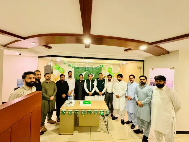 Taimoor Bamazai with a group of colleagues in a decorated meeting room