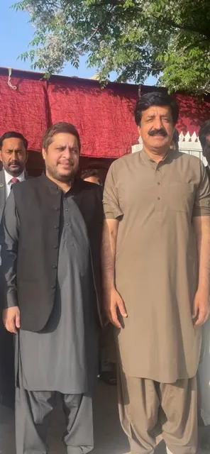 Taimoor Bamazai standing outdoors beside the Governor of Punjab