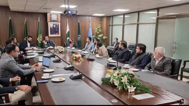 Participants seated around a long conference table