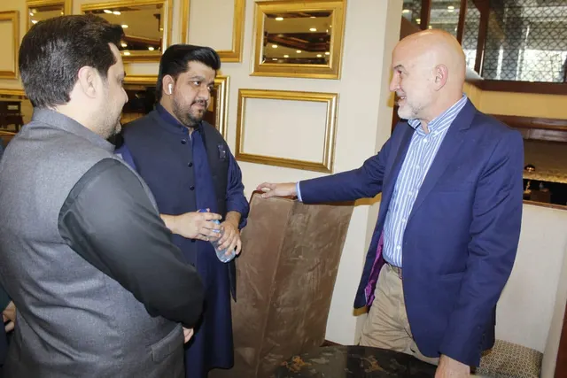 Taimoor Bamazai standing with the Ambassador of Spain and a host